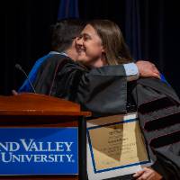 faculty sharing a hug